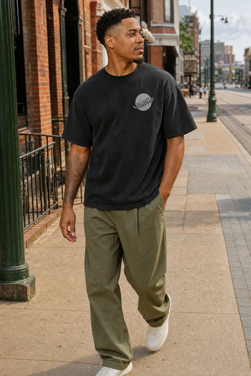 Black model wearing a black Planet Memphis left-chest tee on South Main in Memphis
