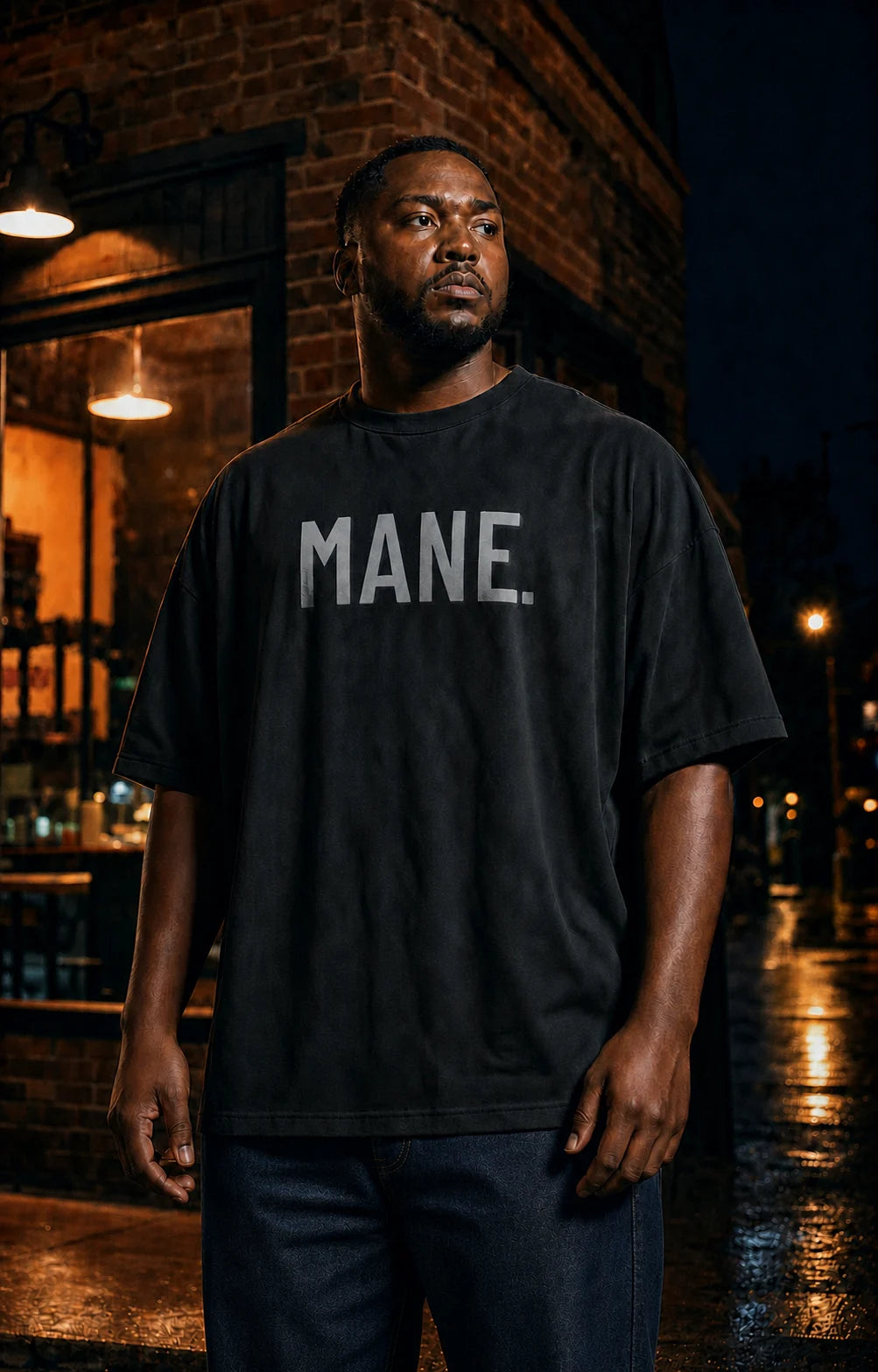 Black model wearing a black MANE. dimensional wordmark tee